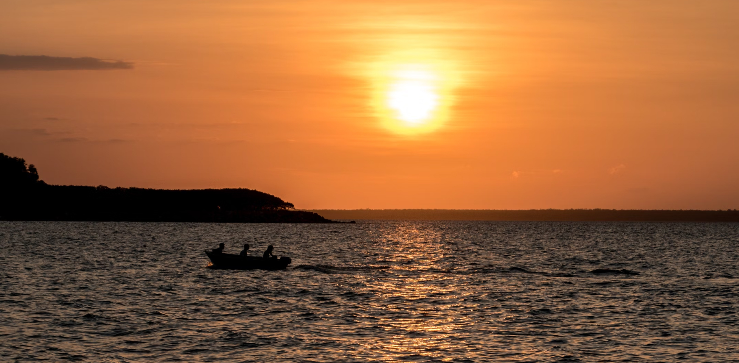 People fishing at sunset